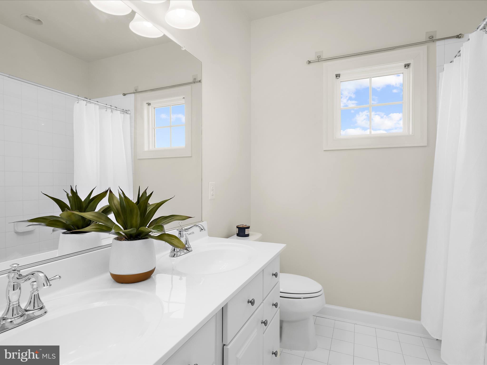 13801 Racetrack Field Court Bowie, MD 20720 - Photo 40 of 66 a bathroom with a sink a toilet and a mirror