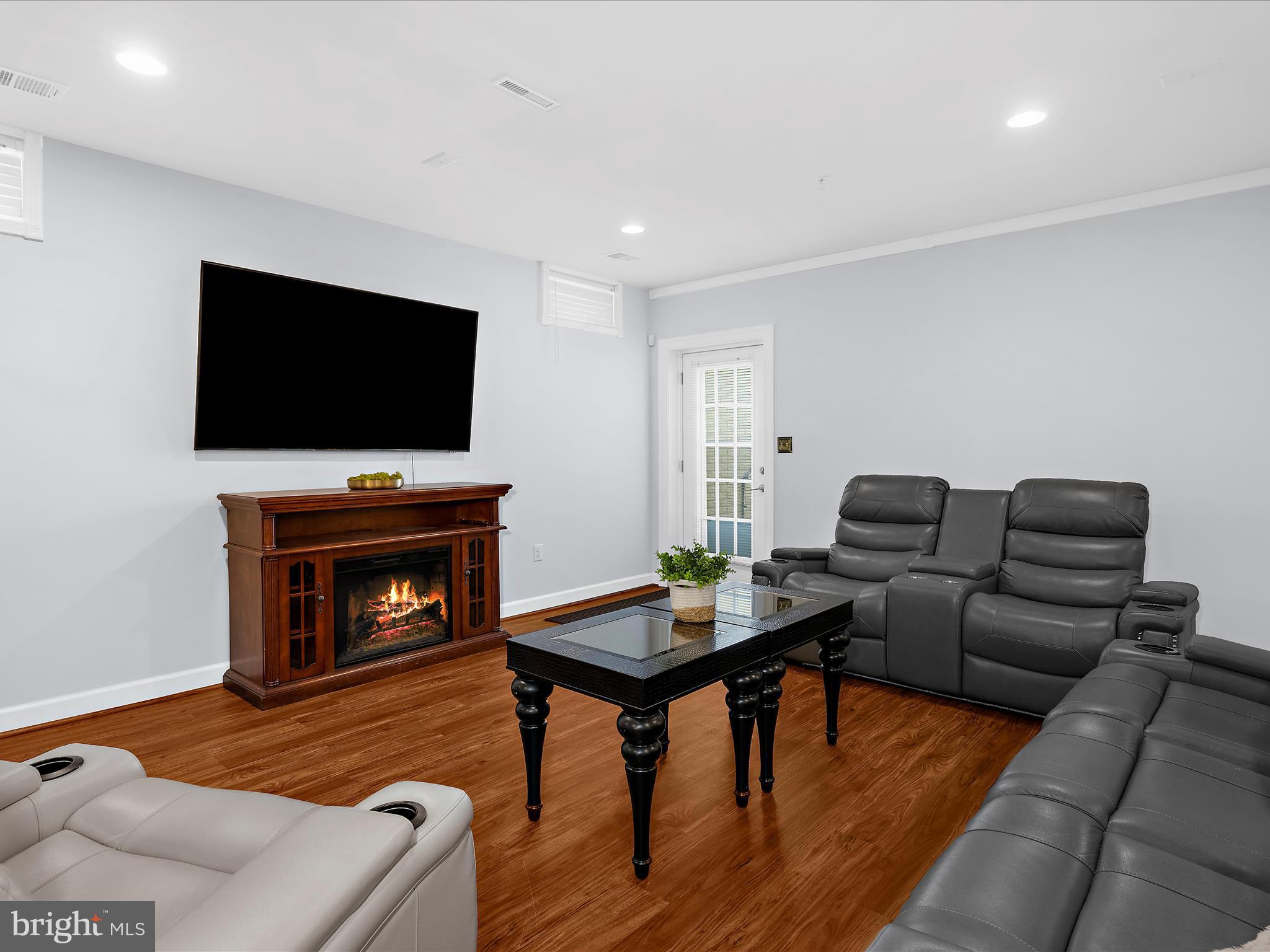 13801 Racetrack Field Court Bowie, MD 20720 - Photo 45 of 66 a living room with furniture and a fireplace