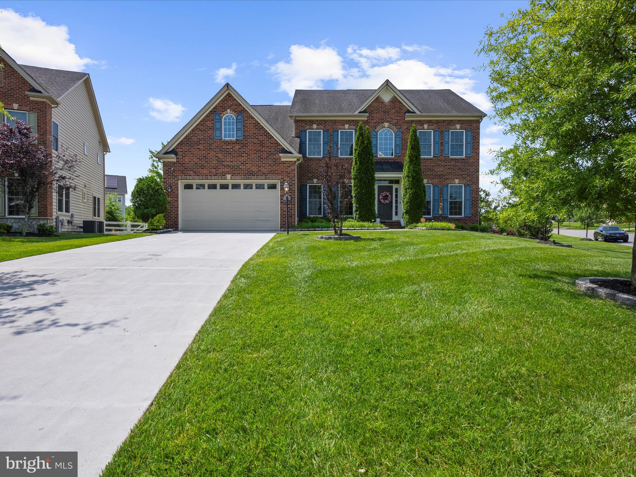 13801 Racetrack Field Court Bowie, MD 20720 - Photo 5 of 66 a front view of a house with a yard and garage