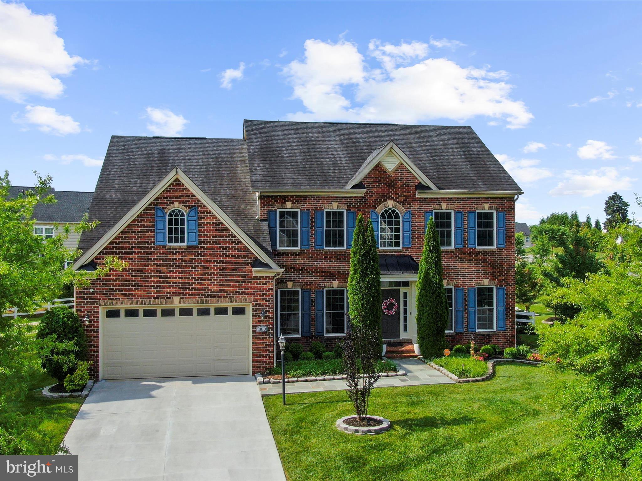 13801 Racetrack Field Court Bowie, MD 20720 - Photo 7 of 66 a front view of a house with a yard and garage