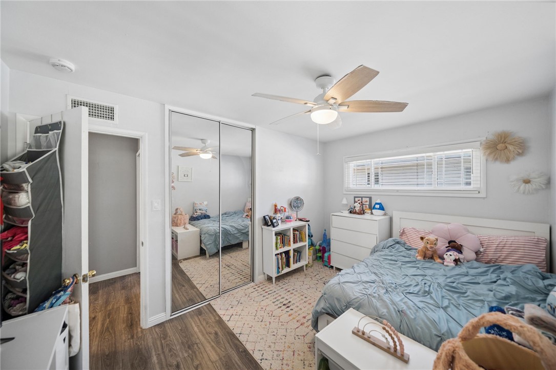 4869 Serrano Place Riverside, CA 92504 - Photo 28 of 40 Additional bedroom view featuring mirrored closet doors, natural light, and ample storage.