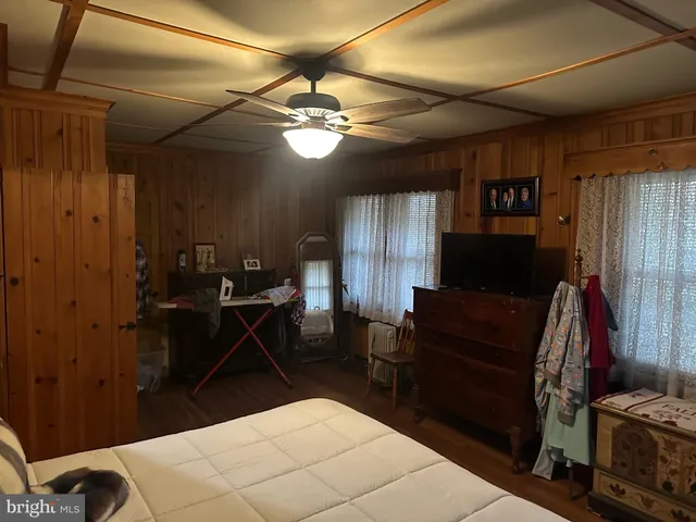 a bedroom with a bed a desk and chair