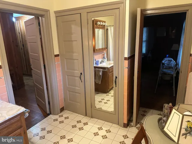 a living room with furniture a flat screen tv and a floor to ceiling window