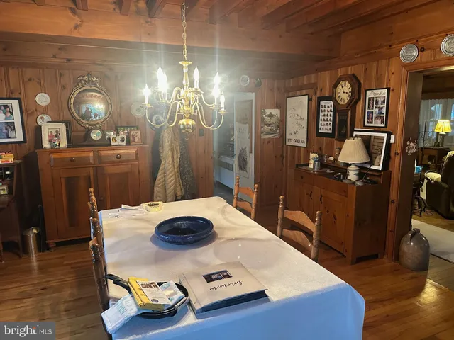 a dining room with furniture and wooden floor