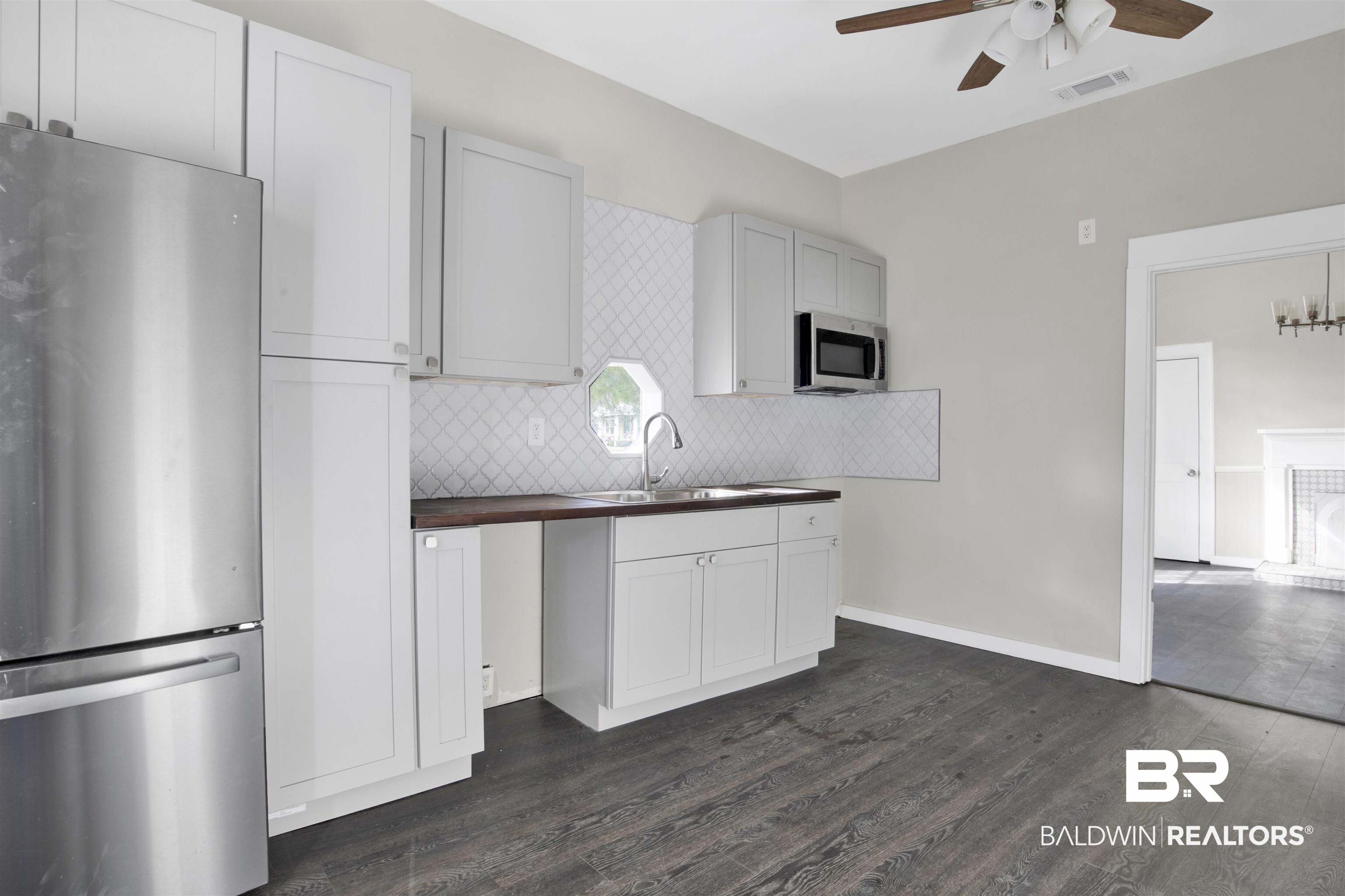 1063 Selma Street Mobile, AL 36604 - Photo 13 of 32 Kitchen with stainless steel appliances, tasteful backsplash, a ceiling fan, dark wood-style flooring, and wooden counters