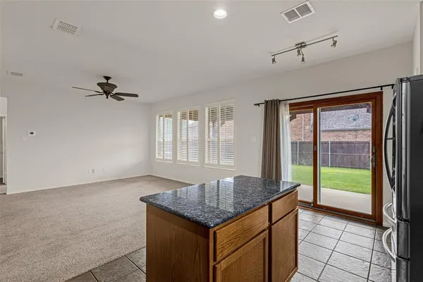 an empty room with a ceiling fan and a window