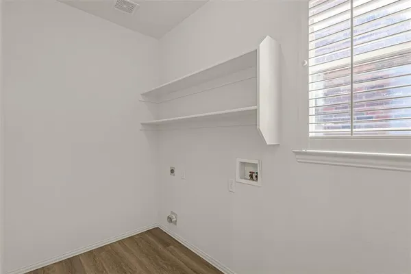 a view of a bedroom with a bed and a window