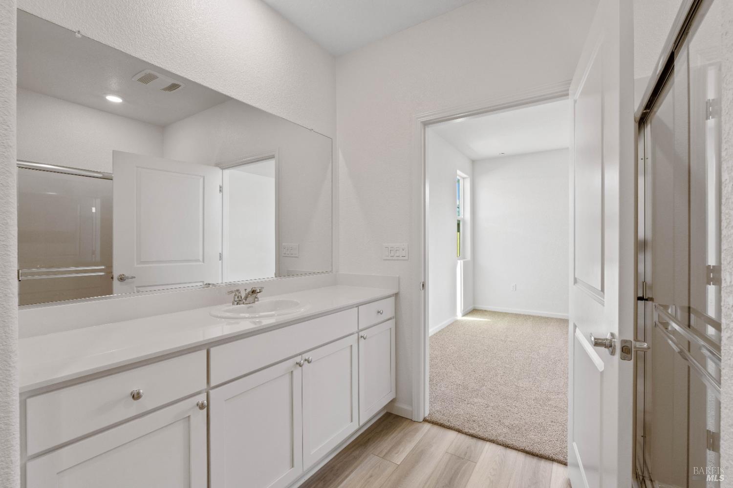 2241 Park Place Rio Vista, CA 94571 - Photo 14 of 17 a en suite bathroom with a granite countertop sink and mirror