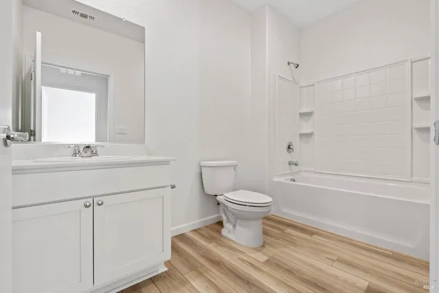 a bathroom with a sink toilet a mirror and shower