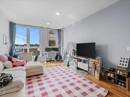 a kitchen with stainless steel appliances granite countertop a stove top oven a sink a dining table and chairs with wooden floor