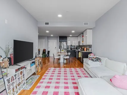 a kitchen with stainless steel appliances granite countertop wooden floor a refrigerator and a stove top oven