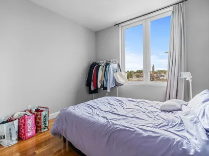 a kitchen with stainless steel appliances granite countertop a refrigerator a sink dishwasher a stove and a dining table with wooden floor