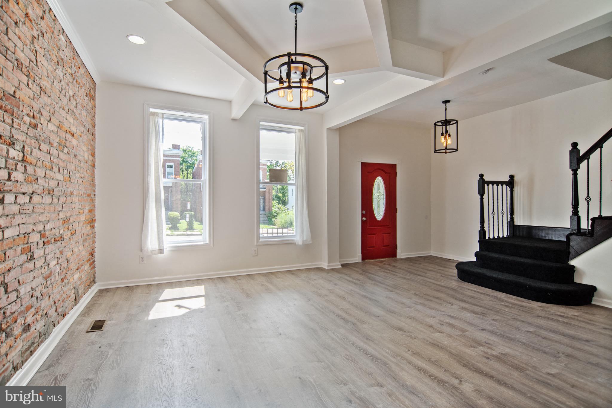 3807 Reisterstown Road Baltimore, MD 21215 - Photo 3 of 25 Exposed brick and tray ceilings in living area.