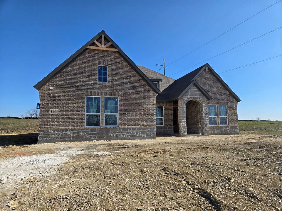 a front view of a house with a yard