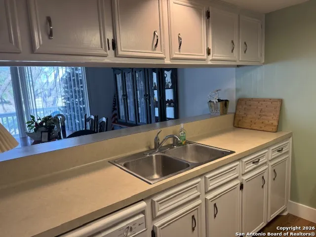 a kitchen with a sink and cabinets