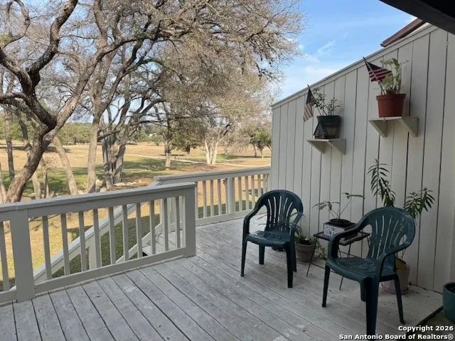 a view of a chair and table in the balcony