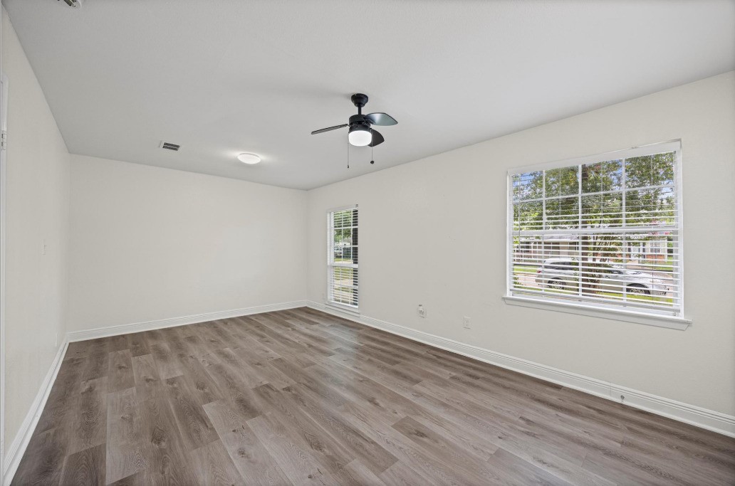 6410 Hartwick Road Houston, TX 77016 - Photo 11 of 16 a view of an empty room with wooden floor and a window