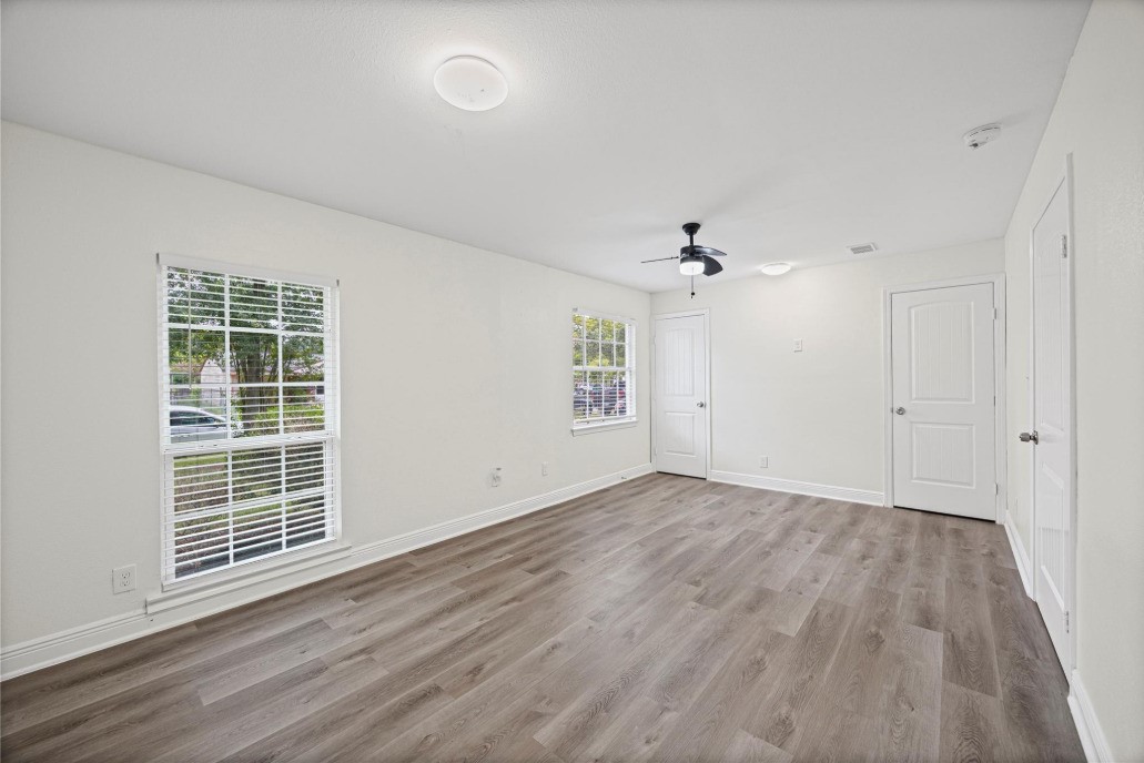 6410 Hartwick Road Houston, TX 77016 - Photo 12 of 16 a view of an empty room with wooden floor and a window