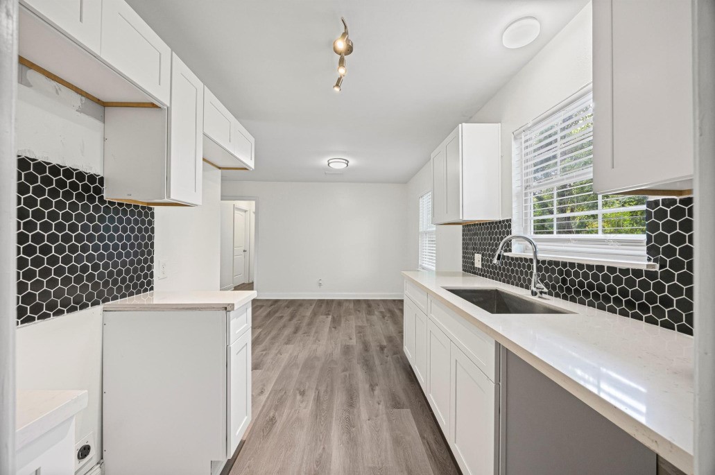 6410 Hartwick Road Houston, TX 77016 - Photo 7 of 16 a kitchen with a sink and wooden floor