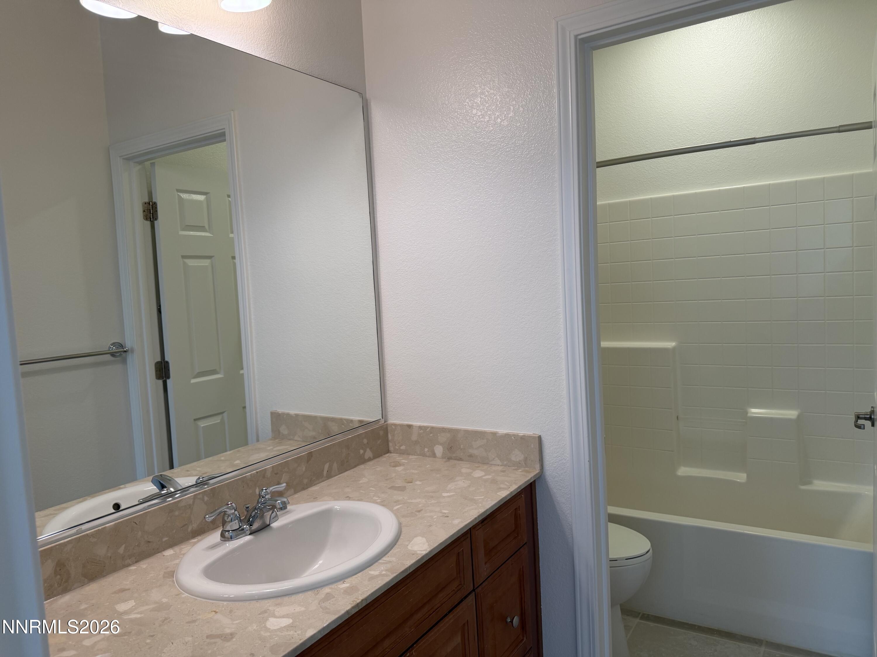 10890 Oakhaven Drive Reno, NV 89521 - Photo 23 of 28 a bathroom with a sink and a mirror
