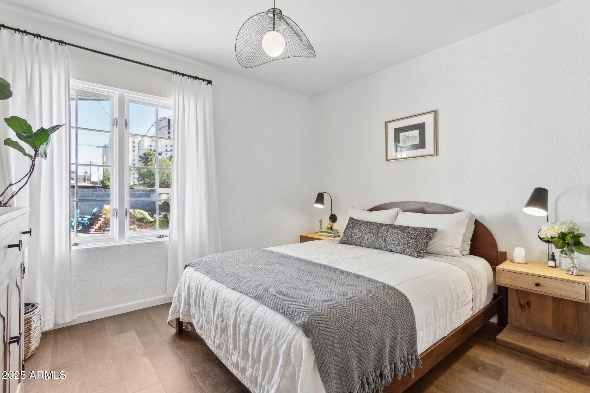 1111 East Coronado Road Phoenix, AZ 85006 - Photo 14 of 77 a bedroom with bed and wooden floor