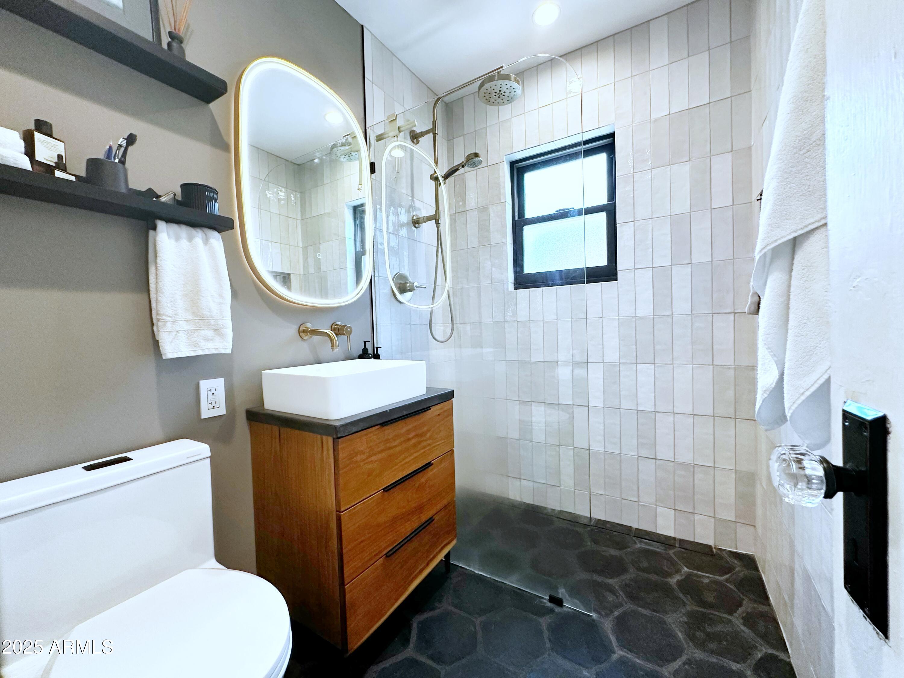 1111 East Coronado Road Phoenix, AZ 85006 - Photo 16 of 77 a bathroom with a sink toilet a mirror and tub
