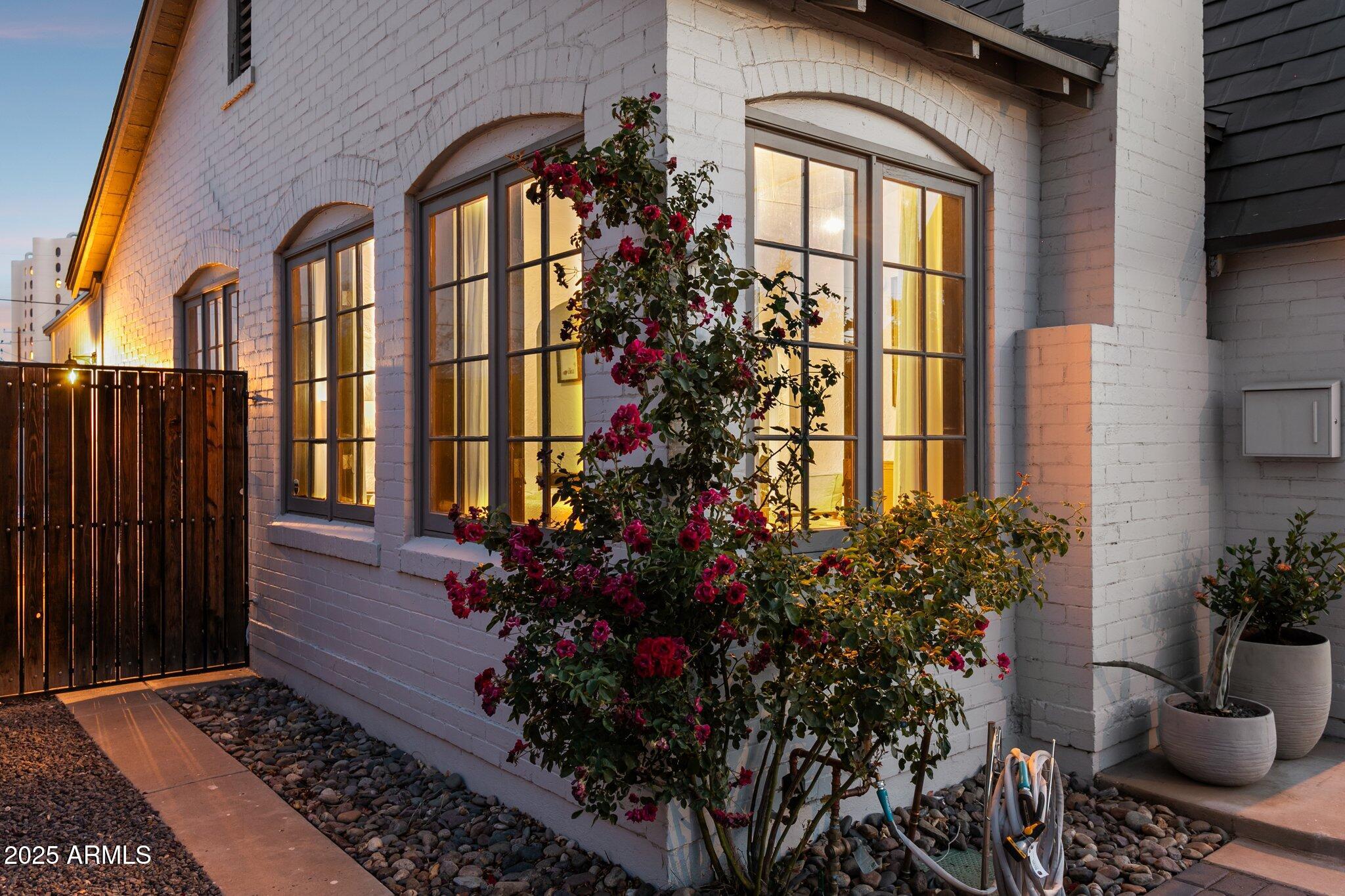 1111 East Coronado Road Phoenix, AZ 85006 - Photo 27 of 77 a vase with flowers sitting on a floor in front of a door