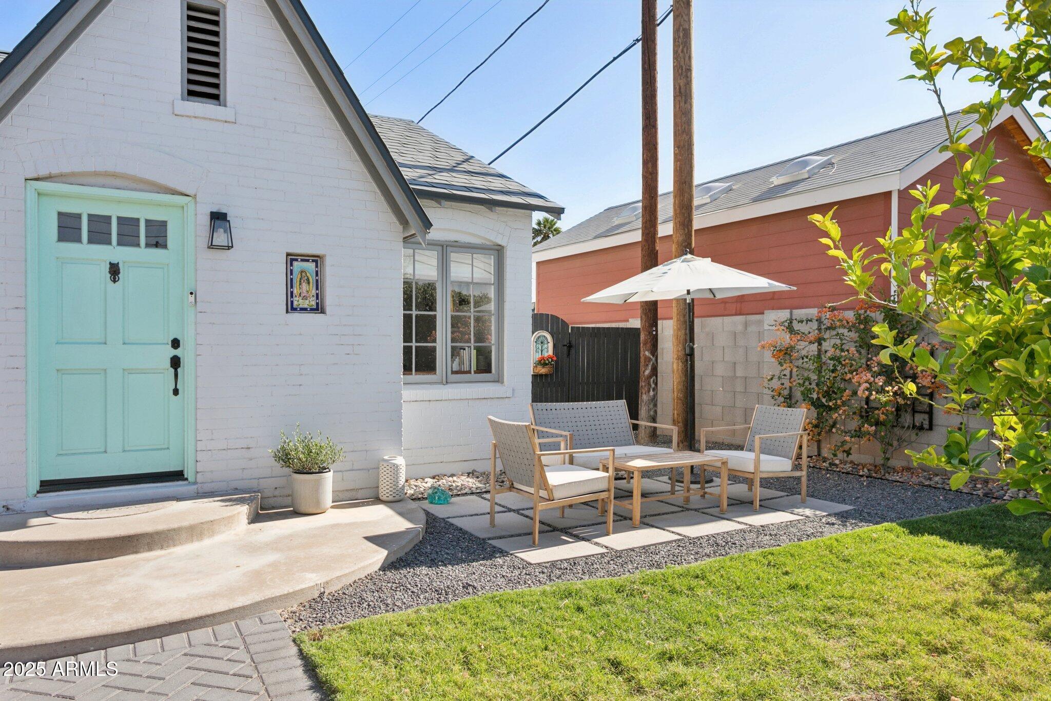 1111 East Coronado Road Phoenix, AZ 85006 - Photo 34 of 77 a patio with a table and chairs under an umbrella