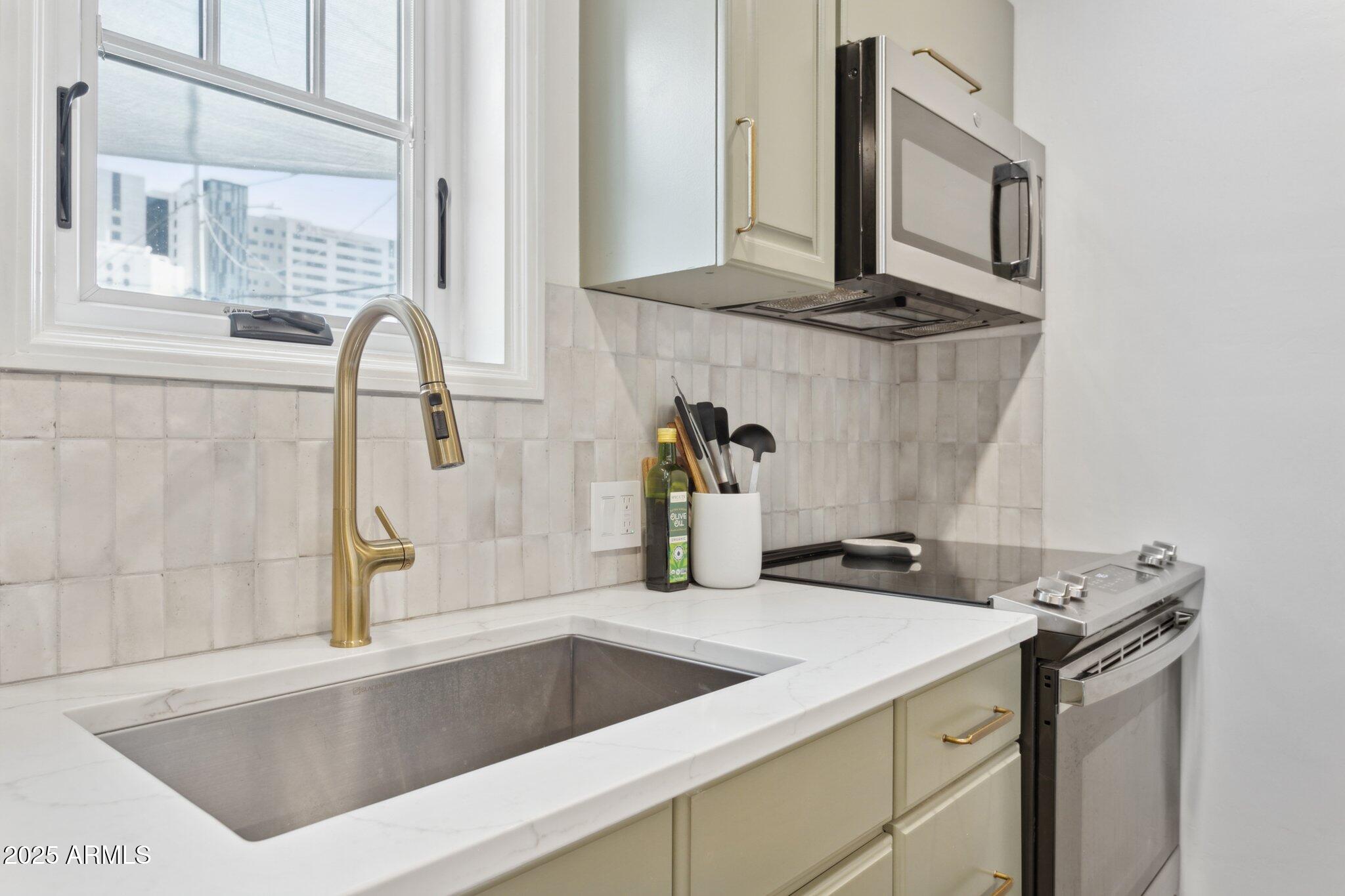 1111 East Coronado Road Phoenix, AZ 85006 - Photo 43 of 77 a kitchen with a sink and a stove top oven with wooden floor