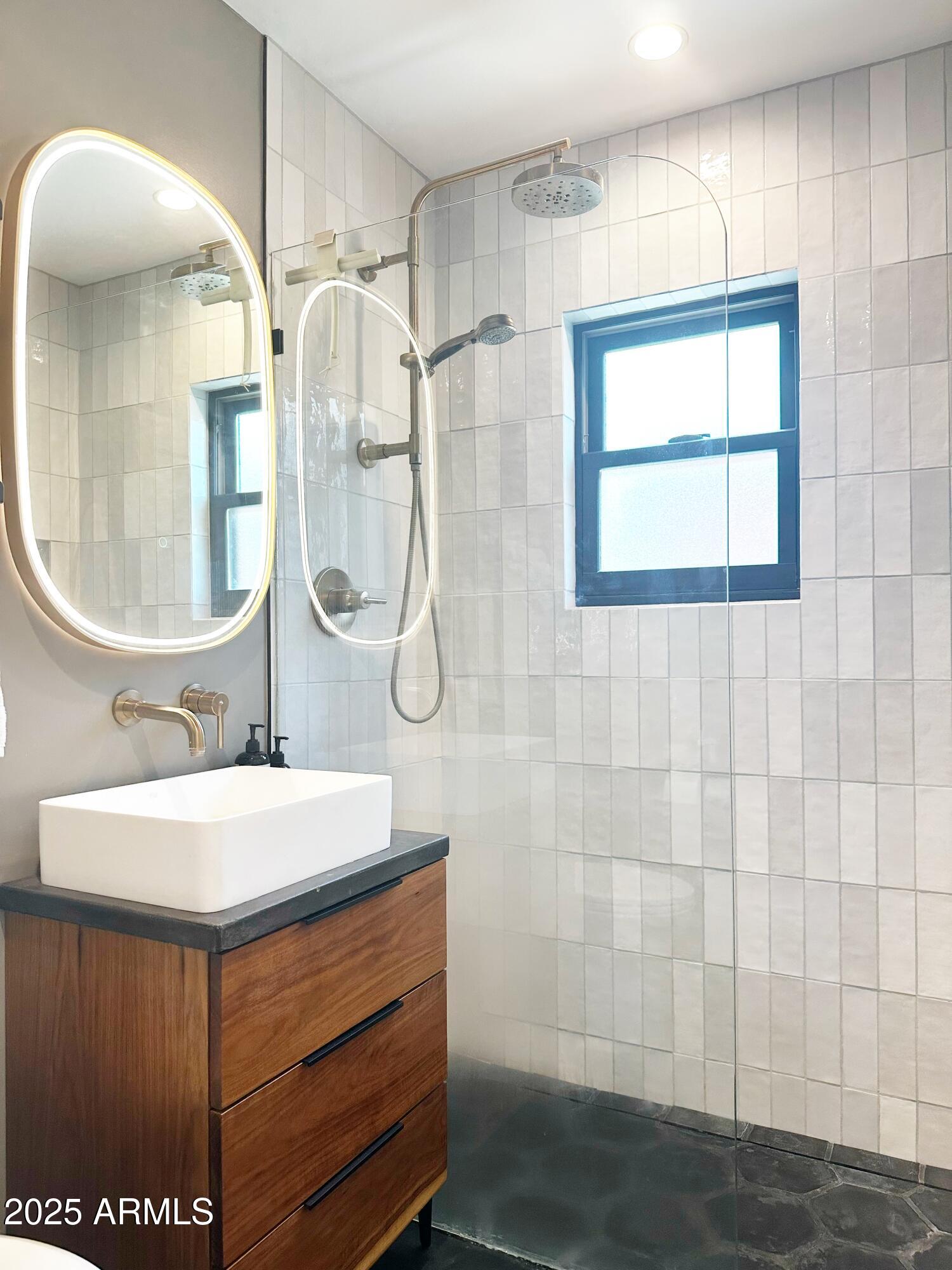 1111 East Coronado Road Phoenix, AZ 85006 - Photo 52 of 77 a bathroom with a sink a mirror a vanity and a shower