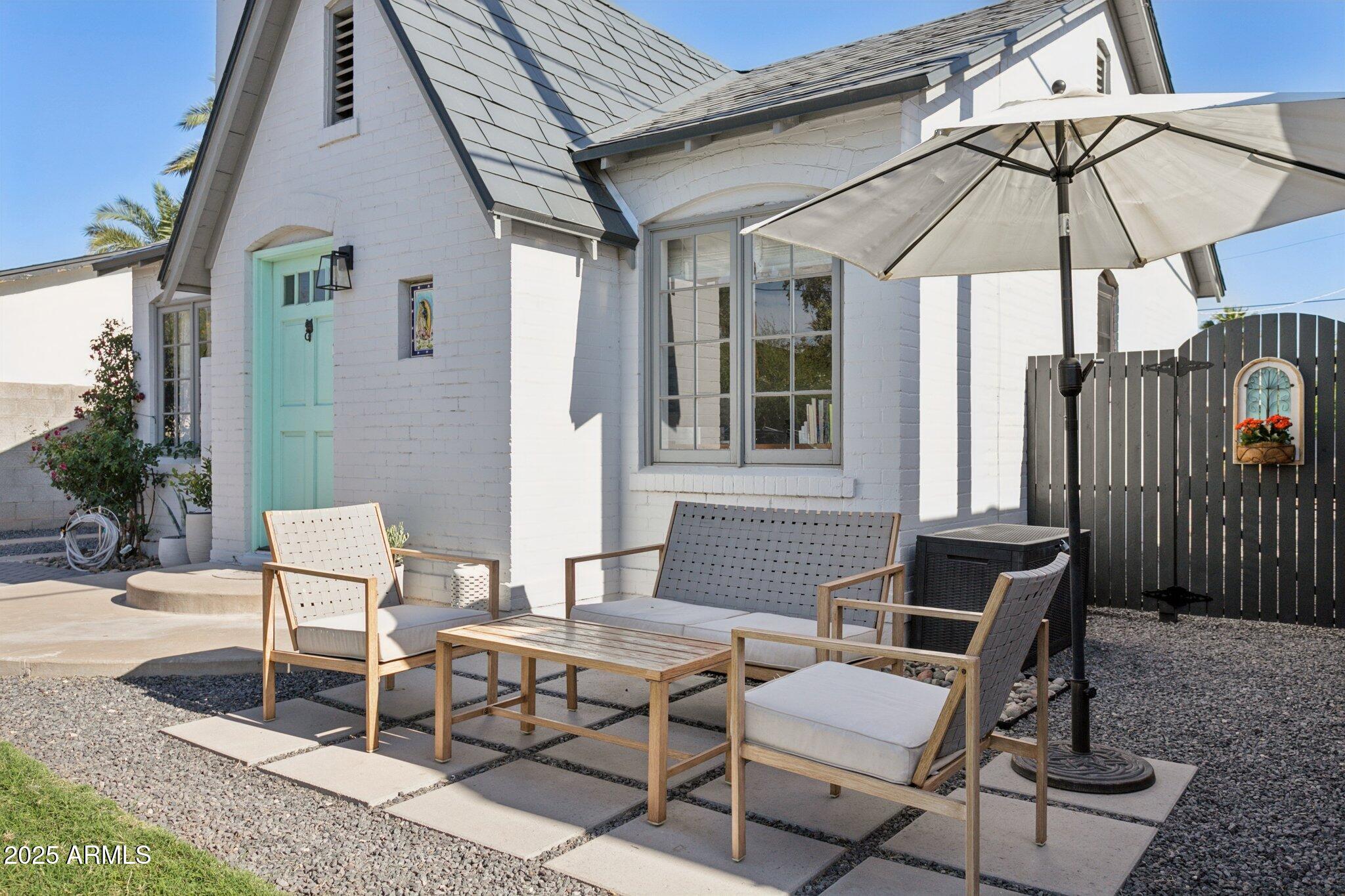 1111 East Coronado Road Phoenix, AZ 85006 - Photo 4 of 77 a patio with a table and chairs under an umbrella