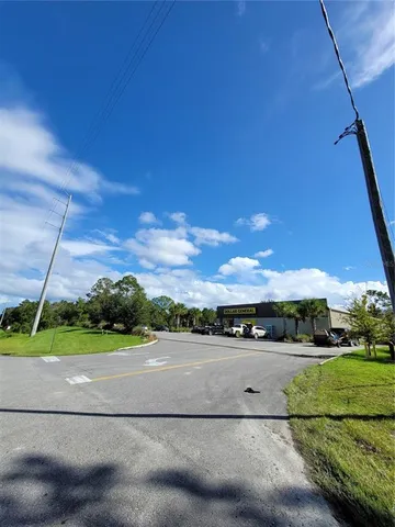 a view of a field with a tree in the background