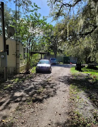 a view of a backyard with large trees