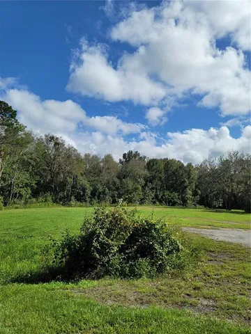 a view of a road with a big yard