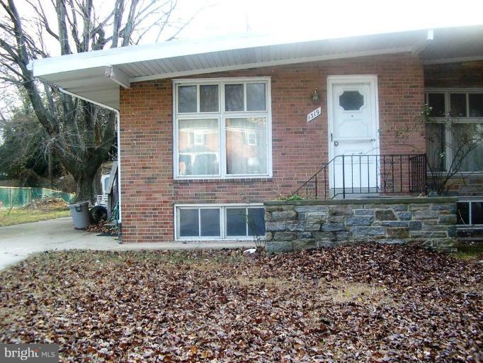 1319 Brixton Road Baltimore, MD 21239 - Photo 1 of 1 a front view of a house with a yard