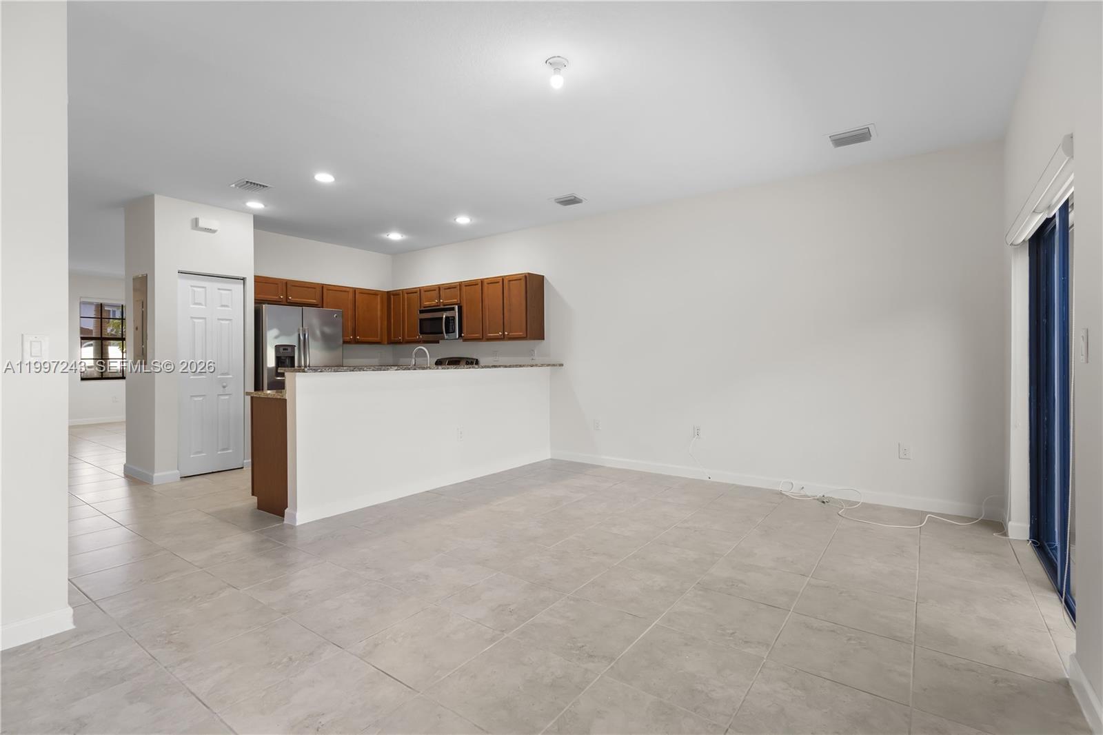 15075 Southwest 113th Terrace Miami, FL 33196 - Photo 13 of 36 a view of kitchen with refrigerator and window