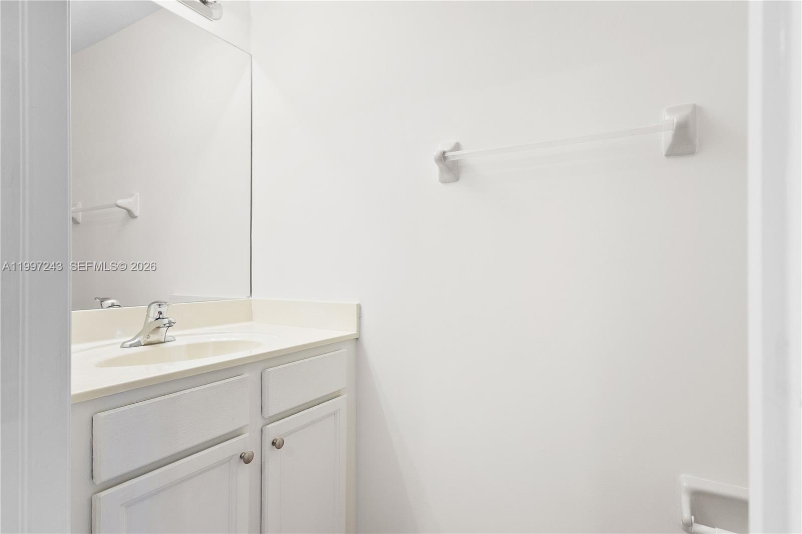 15075 Southwest 113th Terrace Miami, FL 33196 - Photo 16 of 36 a bathroom with a sink and a mirror