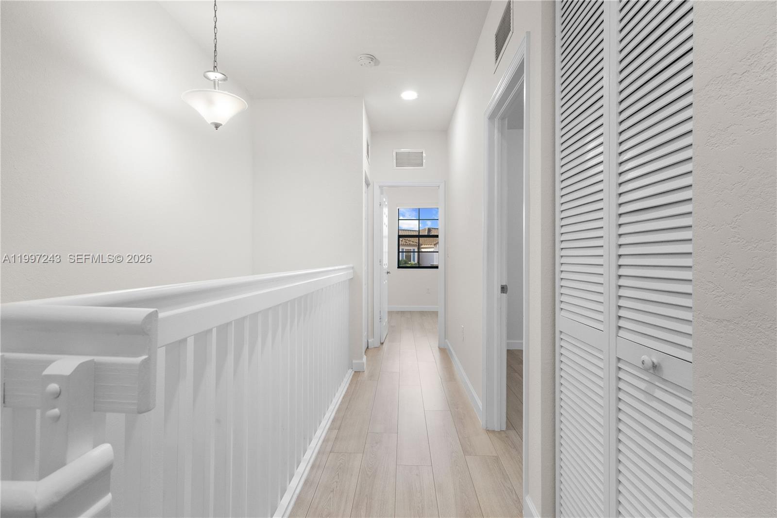 15075 Southwest 113th Terrace Miami, FL 33196 - Photo 17 of 36 a view of a hallway with wooden floor