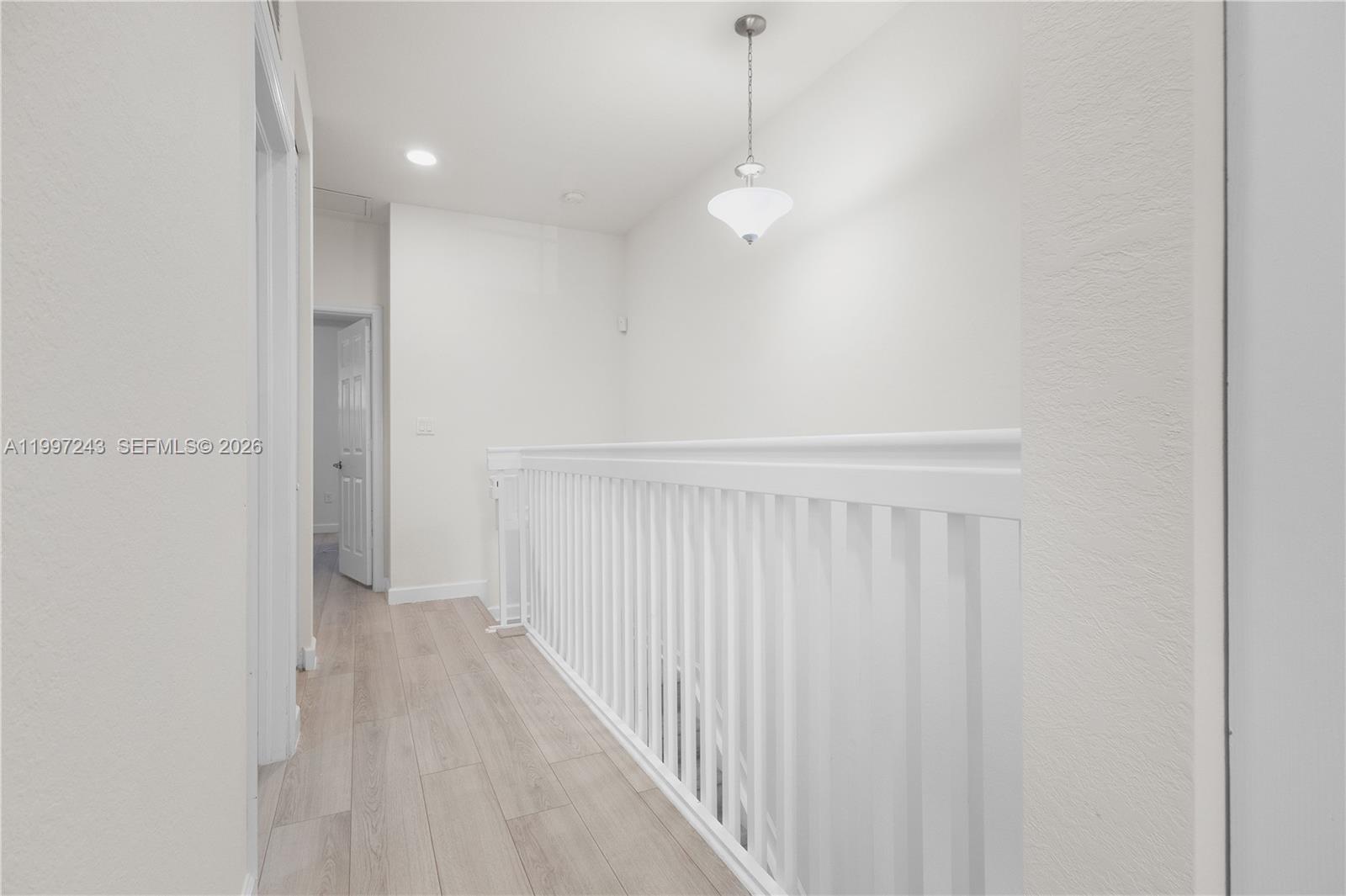 15075 Southwest 113th Terrace Miami, FL 33196 - Photo 18 of 36 a view of a room with a white wall and wooden floor