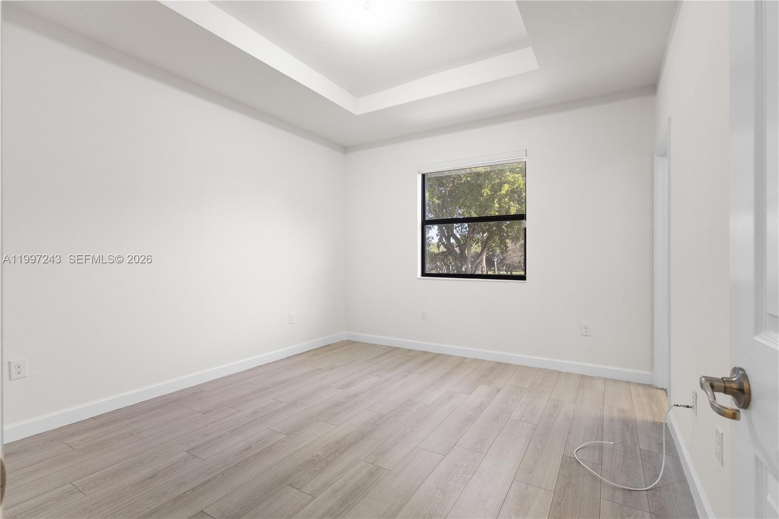15075 Southwest 113th Terrace Miami, FL 33196 - Photo 20 of 36 an empty room with wooden floor and windows