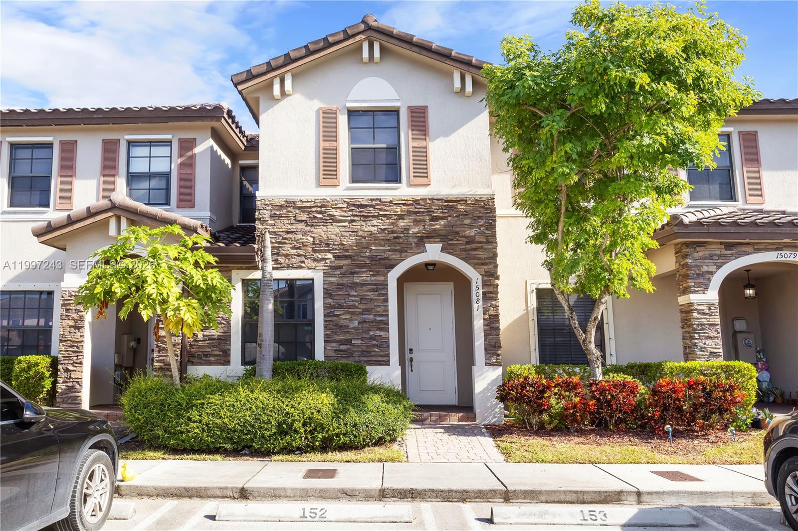 15075 Southwest 113th Terrace Miami, FL 33196 - Photo 2 of 36 a front view of a house with a yard