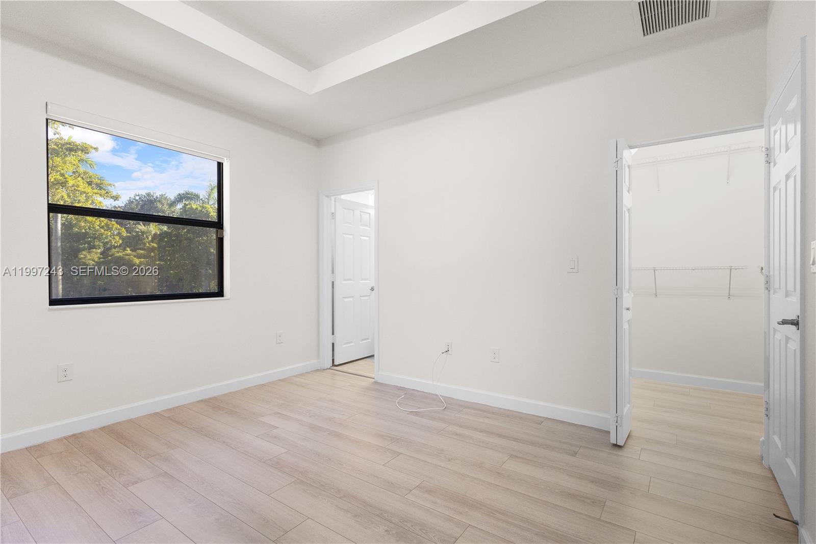 15075 Southwest 113th Terrace Miami, FL 33196 - Photo 21 of 36 a view of an empty room with wooden floor and closet