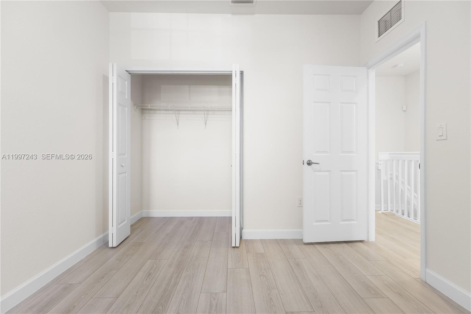 15075 Southwest 113th Terrace Miami, FL 33196 - Photo 27 of 36 a view of an empty room with wooden floor