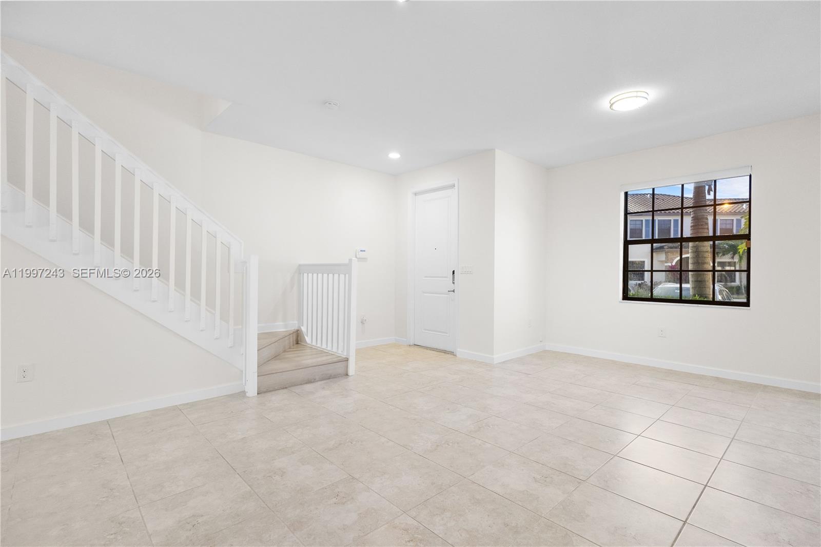 15075 Southwest 113th Terrace Miami, FL 33196 - Photo 3 of 36 an empty room with windows