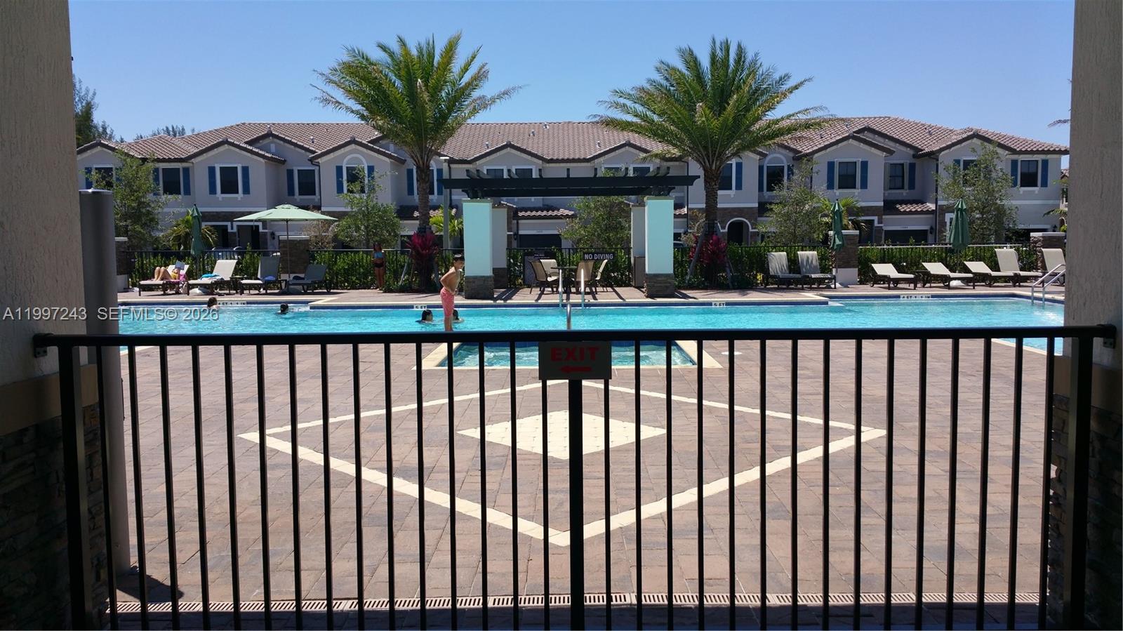 15075 Southwest 113th Terrace Miami, FL 33196 - Photo 36 of 36 a view of a house with wooden fence next to a yard