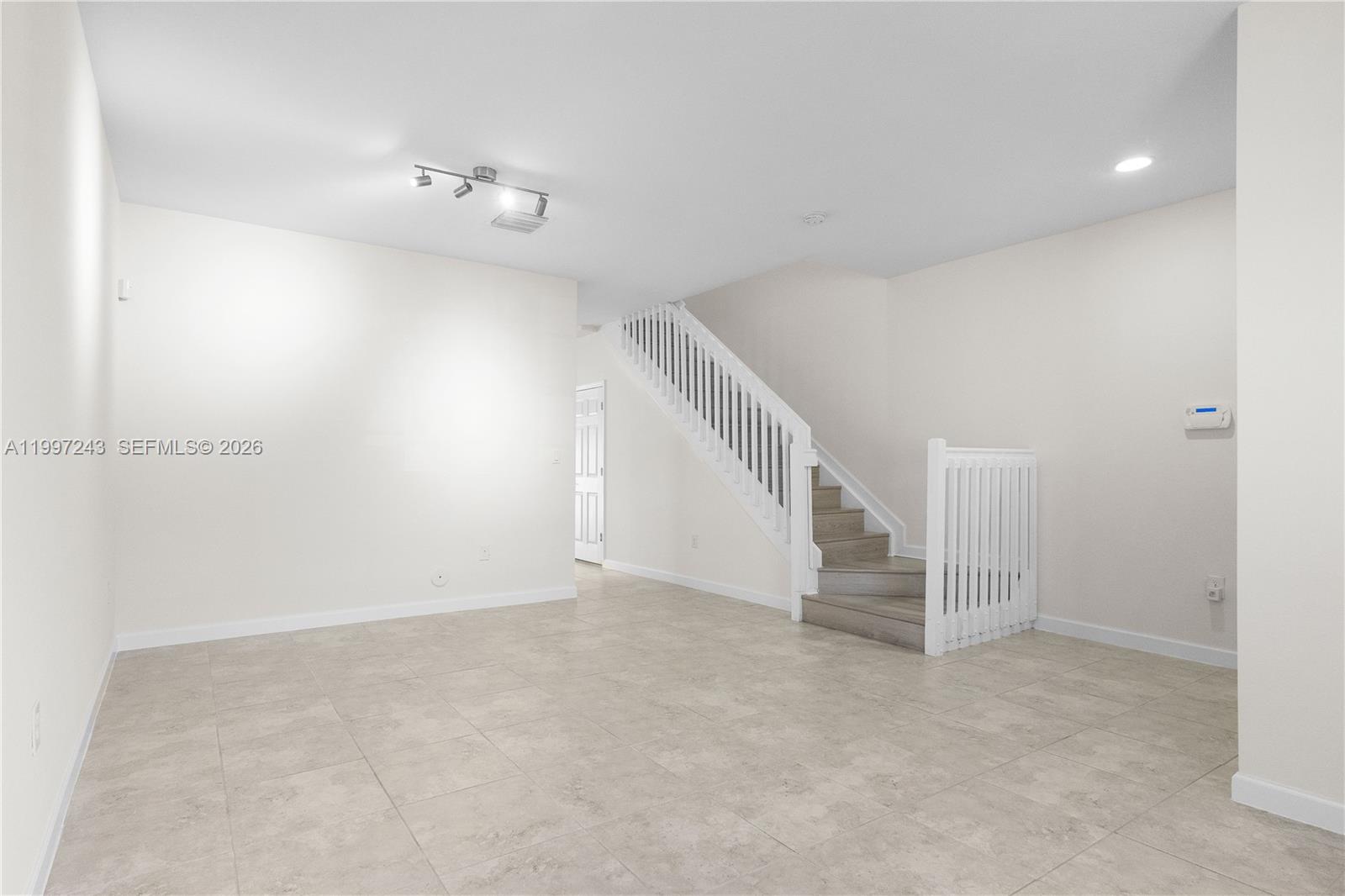 15075 Southwest 113th Terrace Miami, FL 33196 - Photo 6 of 36 a view of an empty room with stairs
