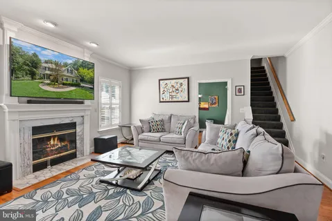 a view of a room with furniture and wooden floor