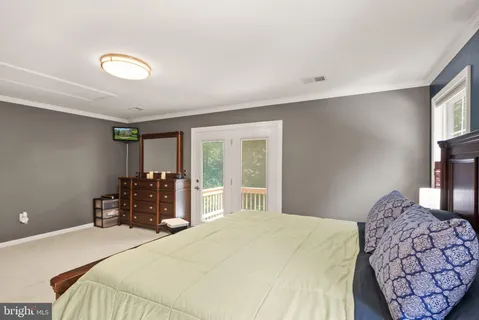 a bedroom with two beds and a dresser with mirror