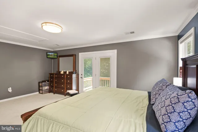 a bedroom with two beds and a dresser with mirror