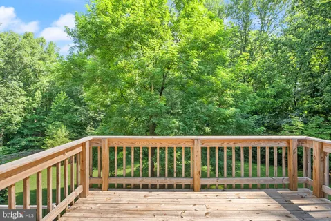 a view of a hallway with workspace and a couch